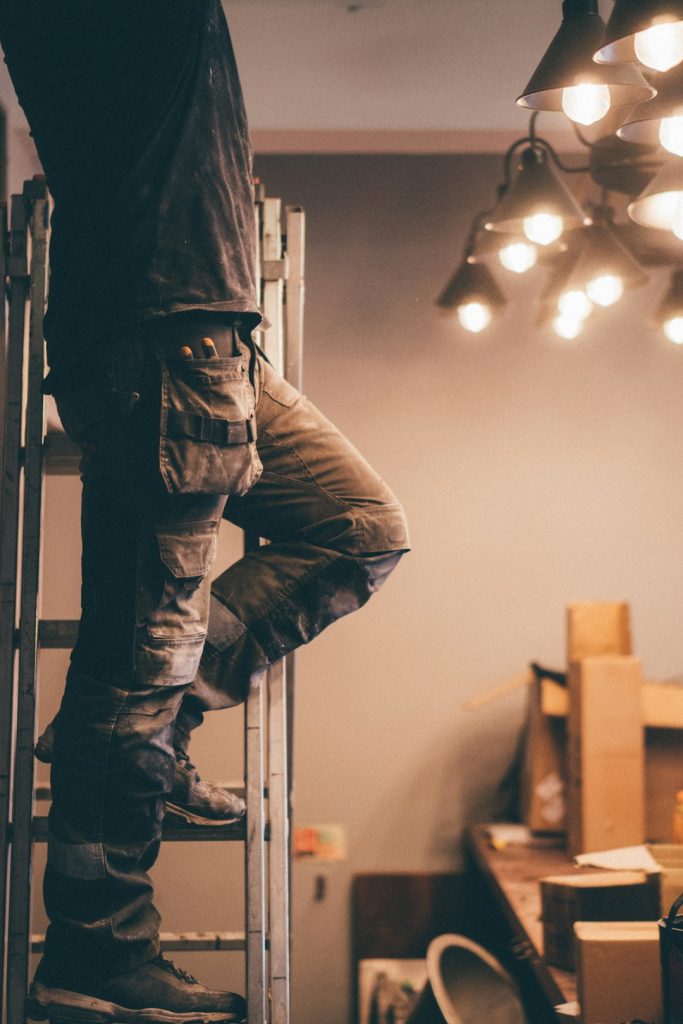 a-person-wearing-jeans-tvpi5phpnfw Worker climbing ladder