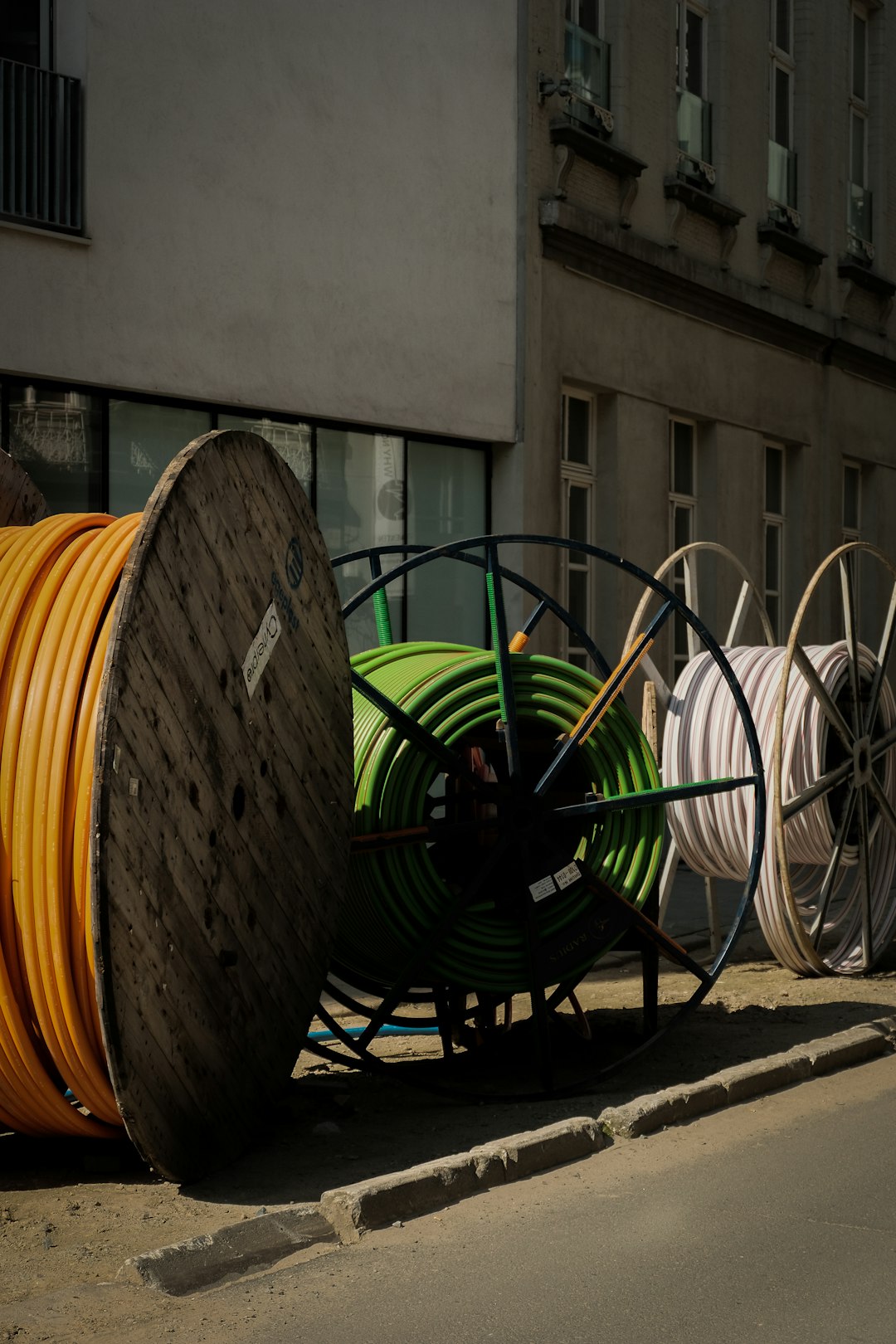 services-01 a-pile-of-yellow-and-green-hoses-sitting-on-the-side-of-a-road-gc85oqrqct0